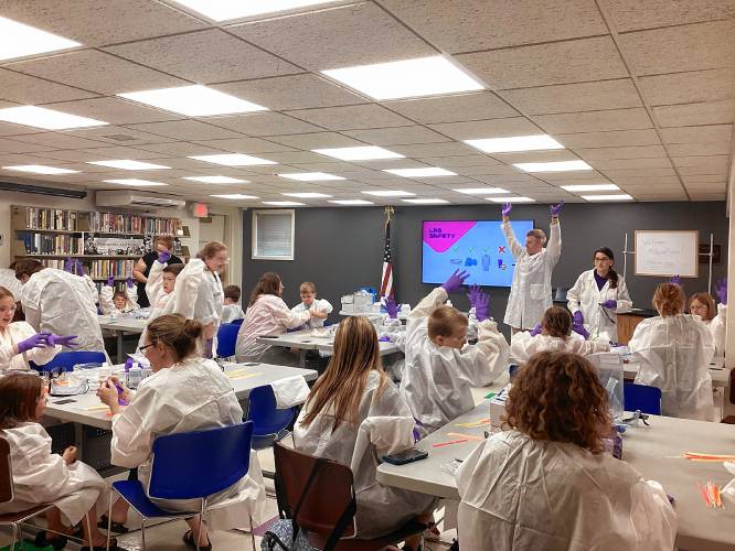 Children at the Jaffrey Public Library participate in the MilliporeSigma Curiosity Lab held at the library last summer with local scientist Terence MacCorvin