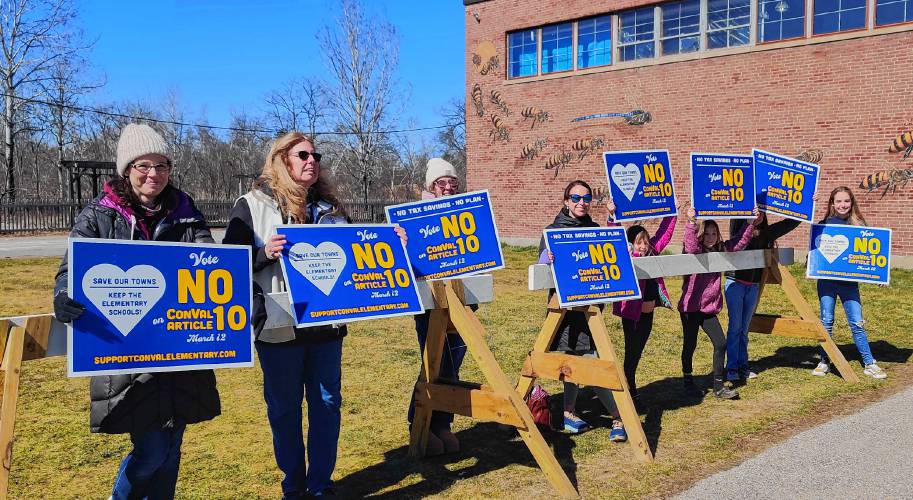  Residents from Temple and Dublin urge residents to vote no on article 10 outside the Peterborough Community Center.