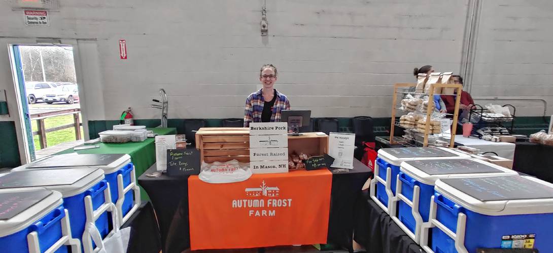 Vendor Amanda Cannon of Autumn Frost Farm displays a variety of fresh pork products.