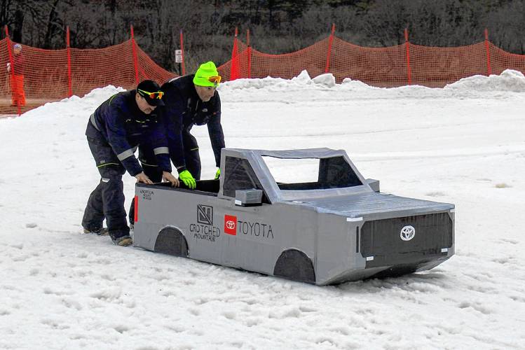 Crotched base operations team members Nate Cross and Ken Webster push the Unofficial Resort Vehicle to the starting line. The Unofficial Resort Vehicle claimed the fastest sled title.