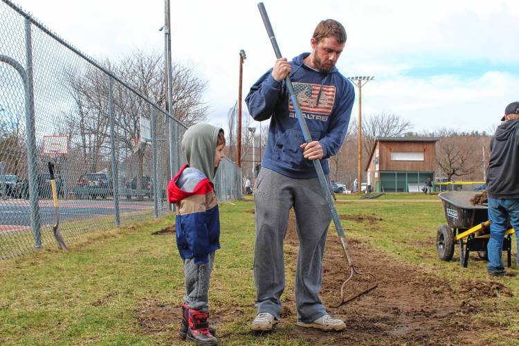 Bob Heggarty and his son R.J. of New Ipswich help with field cleanup.