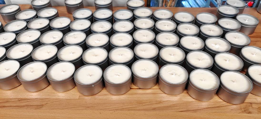 Half-size candle tins await labels in the basement of Leyna and Brian Cannon’s Peterborough home.