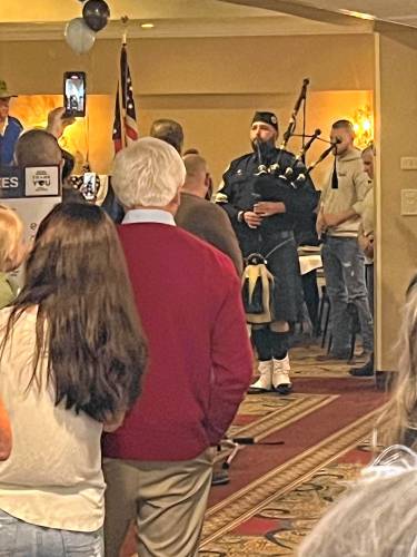 New Hampshire Police Association Maj. David Myer plays the bagpipe.