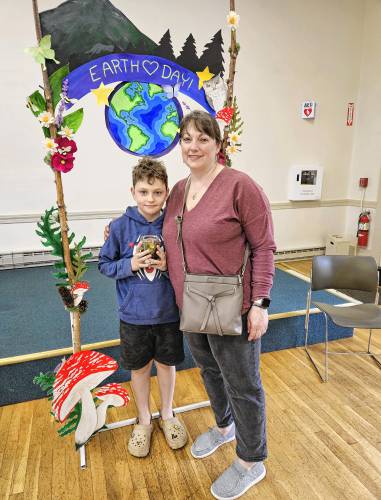 Sarah and Jack Mitchell show off their new terrarium under the Earth Day arbor at the Jaffrey Woman’s Club on Saturday.