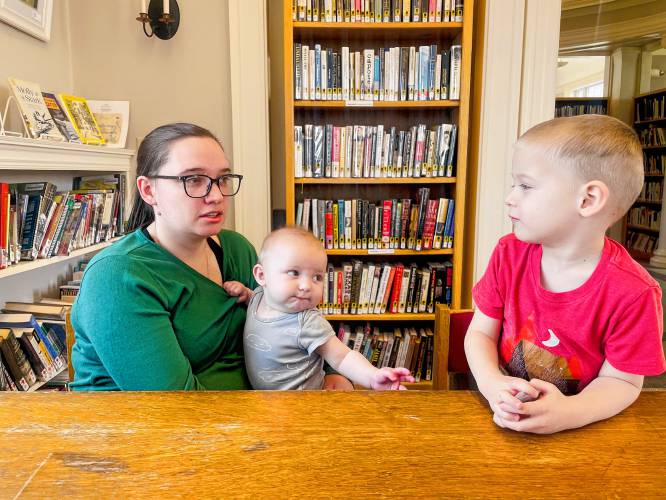 Library Director Ella Cademartori with two of her children, baby Julius and 5-year-old Maximus, at Stephenson Library. 