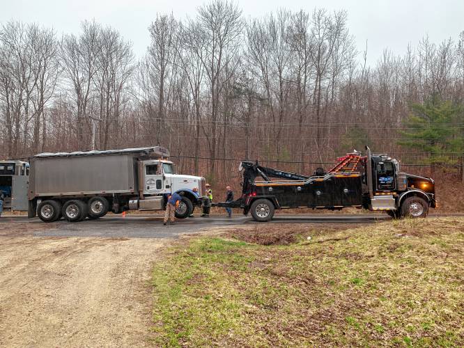 A dump truck involved in a crash on Route 202 on Wednesday afternoon is hauled from the scene by a tow truck.