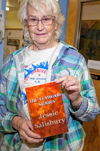 Jessie Salisbury with one of her novels, “The Elmwood Stories.”