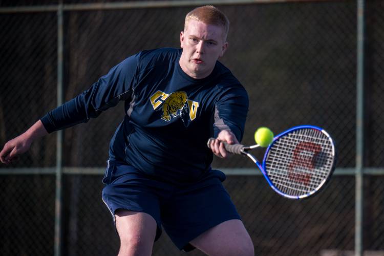 ConVal tennis player Bishop Benham returns a shot against Bow during the Cougars' loss to the visiting Falcons in Peterborough Tuesday.
