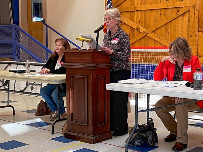 Moderator Dotsie Millbrandt reads the rules for Town Meeting, flanked by Town Clerk/Tax Collector Deb Morrison and Board of Selectmen Chair Kate Batcheller.