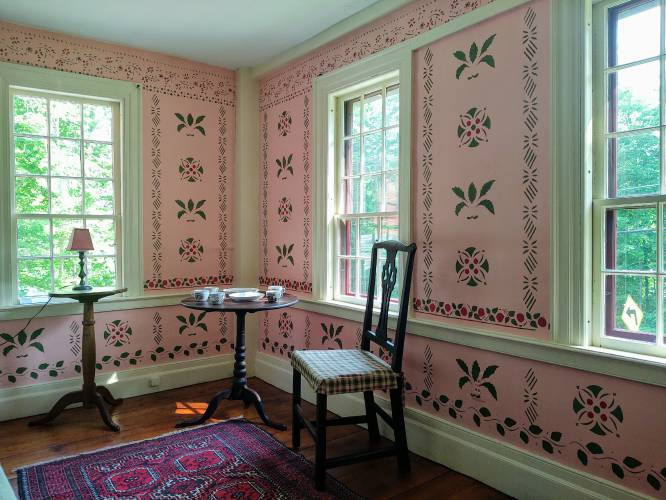 The hand-stenciled main bedroom. 