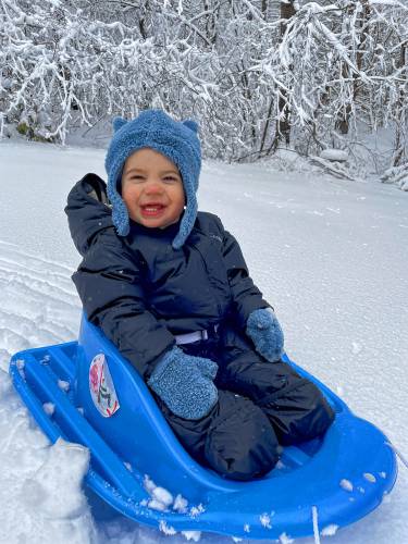 Hunter Peard of Rindge, 1, enjoys the snow on his sled.