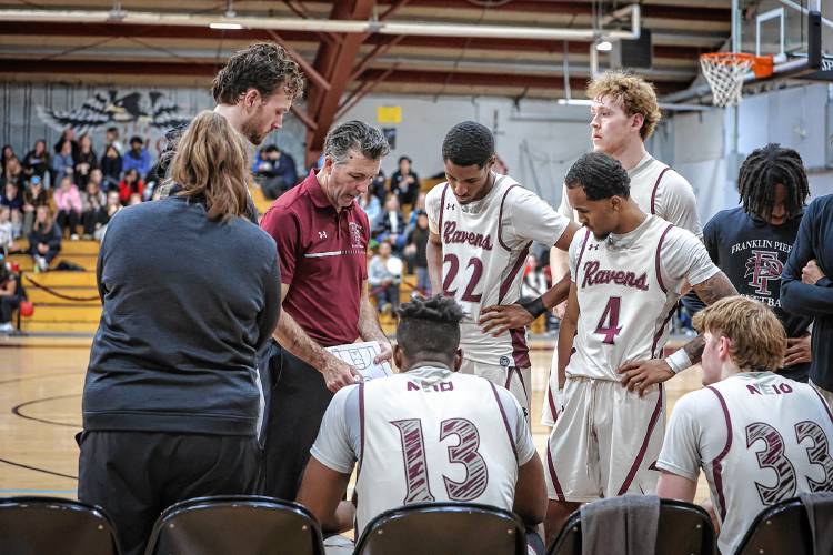 Franklin Pierce head coach Mike Ruane talks to his players during a timeout.