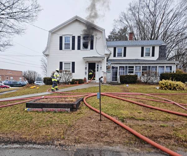 Smoke comes out of a second-floor window on Stratton Road March 28.
