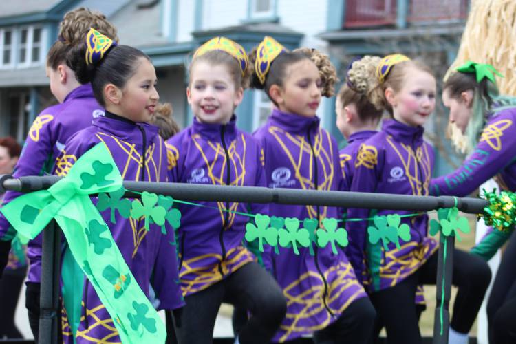 The Flying Irish Dancers out of Ashby, Mass., perform a dance atop their float.