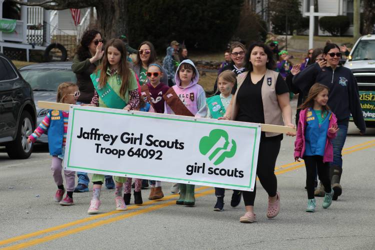 Girl Scout Troop 64092 of Jaffrey marches in the parade and waves to onlookers.