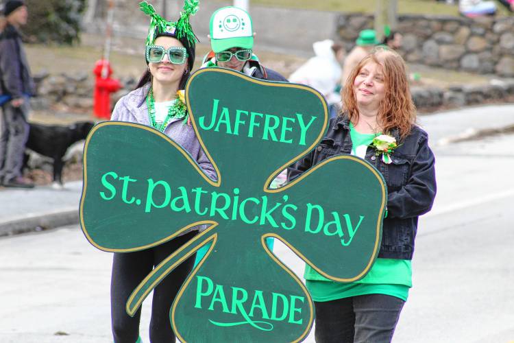 Rachel Kennedy and Tina LeBlanc carry the Jaffrey St. Patrick’s Day parade sign at the head of the parade.