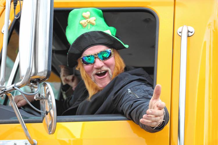 Jaffrey Highway Department employee Steve Hruska drives a town truck in the parade while wearing a shamrock hat and Leprechaun-esque red beard.