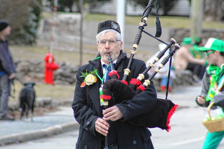Bagpiper Mark Polifrone of Marlborough plays as he marches at the top of the parade.