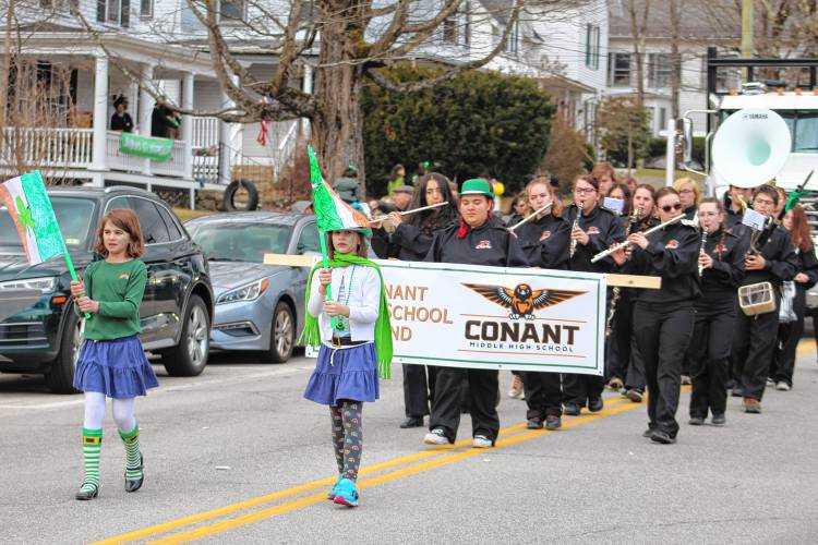 The Conant High School Band plays “Uptown Funk” while marching down Main Street.