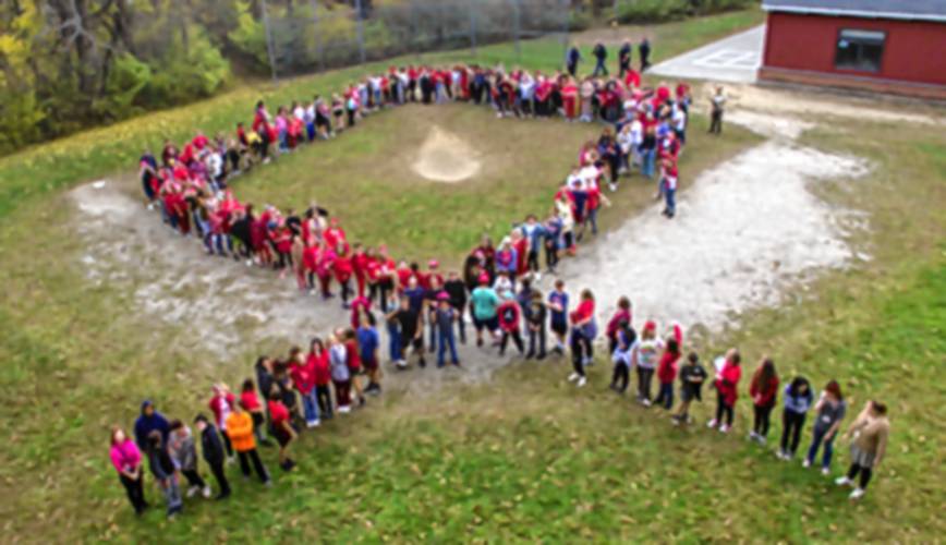 Great Brook School students pose in the shape of a ribbon as a visual statement to choose to be drug-free.