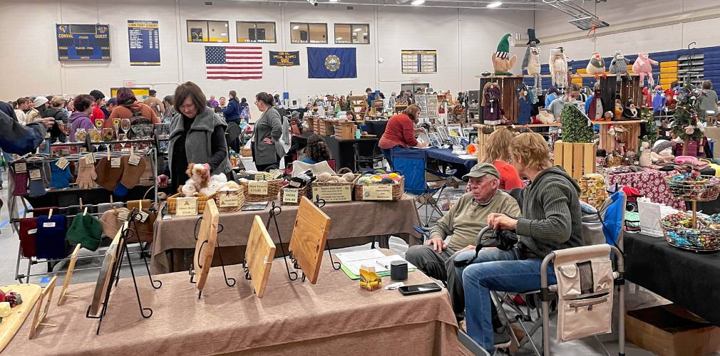 Crafters amd shoppers fill the ConVal High School gym at the school’s holiday craft fair Saturday.