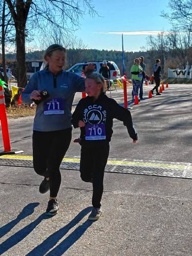 RIGHT: Jaylyn Paul finishes first among the women at the Peanut Butter Chip Chase.FAR RIGHT: Mother-and-son finishers Nicole and 8-year-old Ryleigh Letourneau of Rindge.