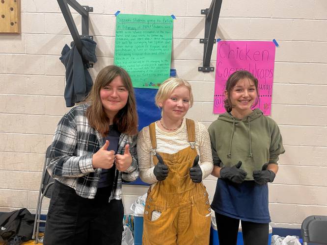 Amanda Bergeron, Heidi Bell and Sophia Judd raise money for the science department trip to Belize. 