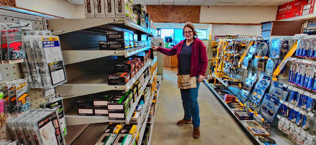 Lisa Belliveau stocks the shelves of Happy Hardware.