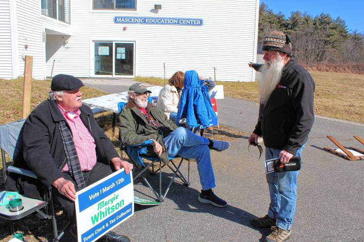 Ken Whitson campaigns for his wife, Margie Whitson, outside the polls on Tuesday.