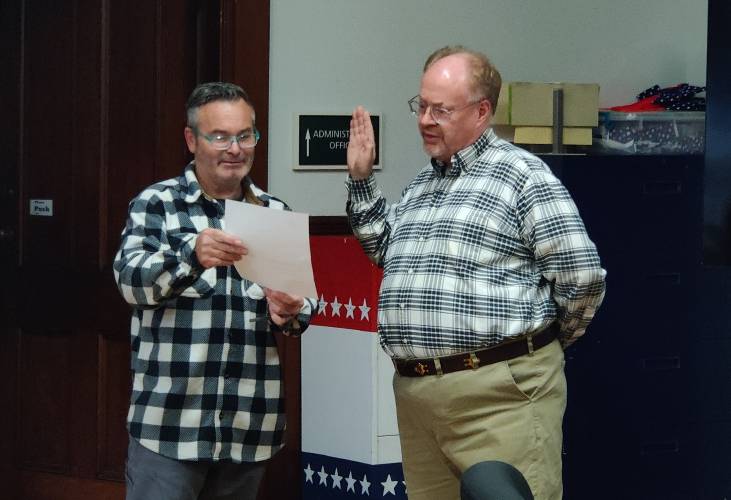 New Select Board member Tom Schultz is sworn in by outgoing Chair Matt Fish.