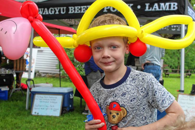 John Suiter, 6, of Mason, toured the market with a balloon hat and sword made at one of the booths. 