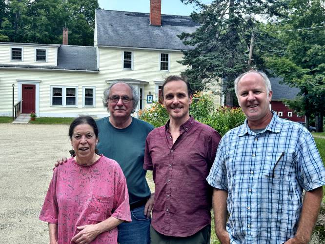 Del Rossi’s founders Elaina and David Del Rossi (left) pose with new owners Wayne Asbury and Bill O’Mahony in front of Del Rossi’s a few days after closing the deal on the sale of the restaurant. 