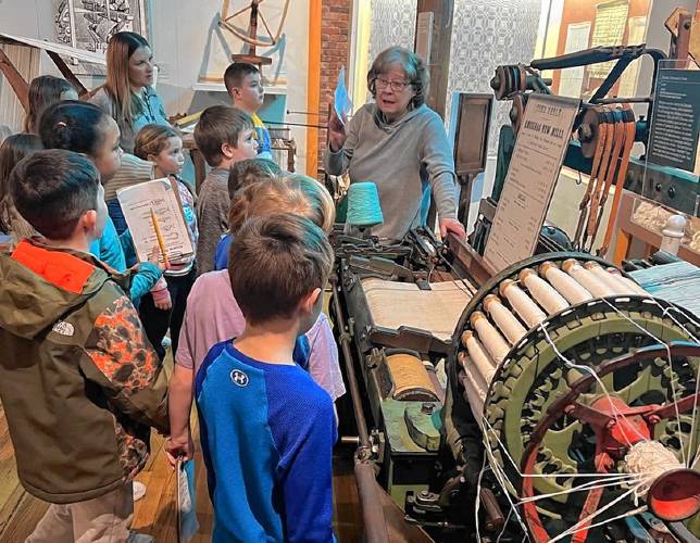 Greenfield Elementary School students learn about a printing press at the Millyards Museum. 