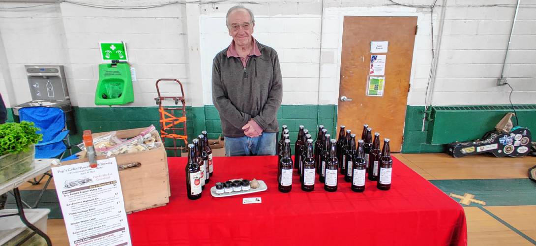 Vendor Rich Stadnik of Pup’s Cider displays his craft cider, seasonings and dehydrated apple snacks.