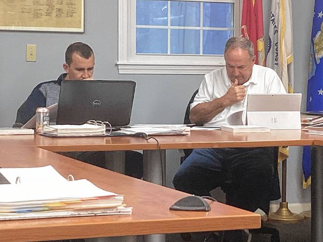 Zoning Board members Walker Farrey and David Lage deliberate on a proposal for short-term rental cabins at Old Homestead Farm during a meeting on Thursday.