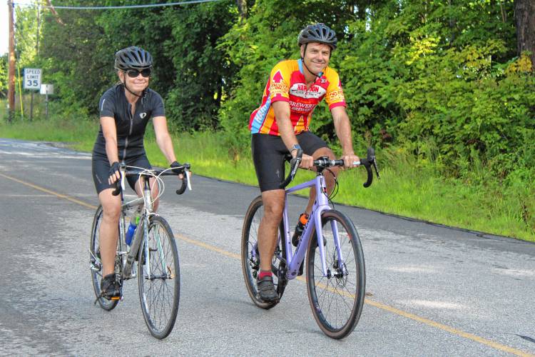 Jill and Charlie Bent of Cambridge, Mass., ride off at the start of the Rose Mountain Rumble on Saturday.