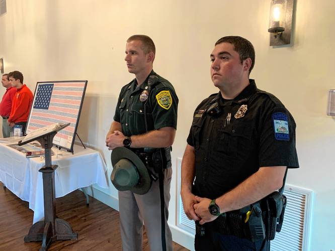 Police officers Paul Bergeron of the New Hampshire State Police and Troy Ashmore of the Rindge Police Department pay respects to those who lost their lives on Sept. 11.