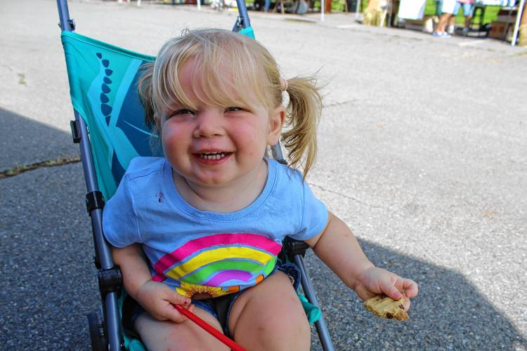 ABOVE: Phoebe Jenks, 1, of Peterborough, enjoys a cookie from the baked goods sale during Greenville Old Home Day.