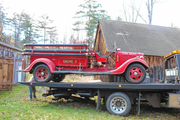 The muster truck is loaded onto a tow bed, ready to be transported to its new home at Blanchard’s Auto Salvage, where volunteers plan to restore it.