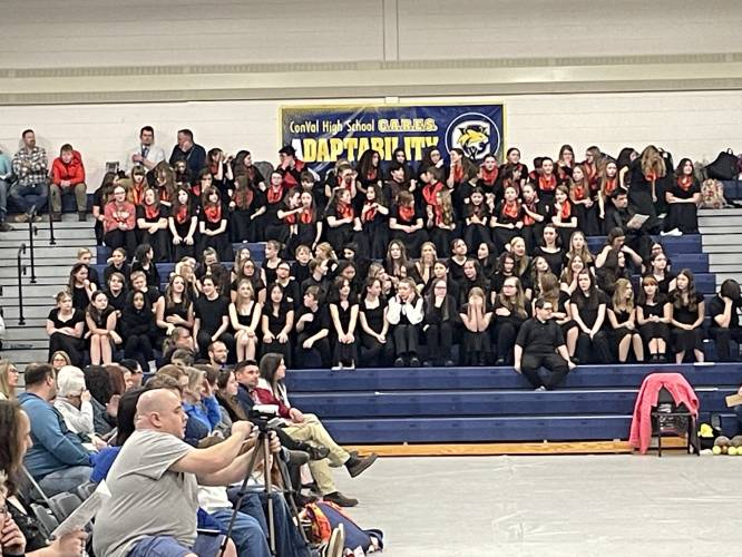 The Great Brook Singers, top, with red scarves, and the SMS Select Choir, lower bleachers. 