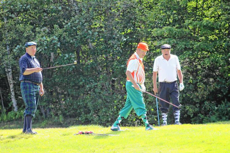 Andy Lawn, Mark Chamberlain and Mark Norby seek out their best-positioned golf ball.