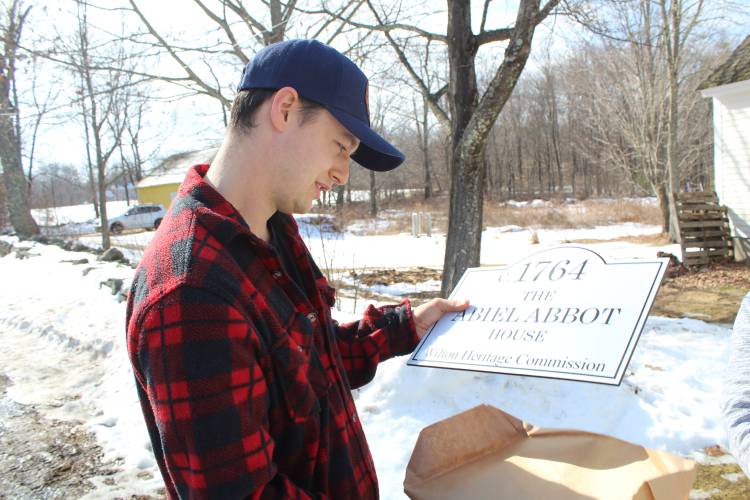 Samuel Cochrane accepts a new sign for his house built in 1764 on Saturday.