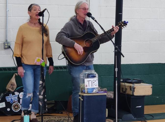 Susan Lang (left) and David Young of the band Eyes of Age provide musical entertainment.