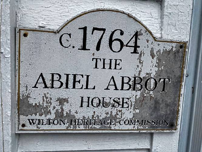 A faded hand-painted sign for 676 Abbot Hill Road will be replaced with a new sign in the same style, as part of a fundraiser for the Wilton Heritage Commission.