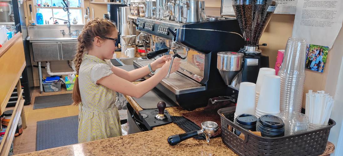 Eleanor Parker prepares a shot of espresso behind the counter of Parker and Sons Coffee Roasting.