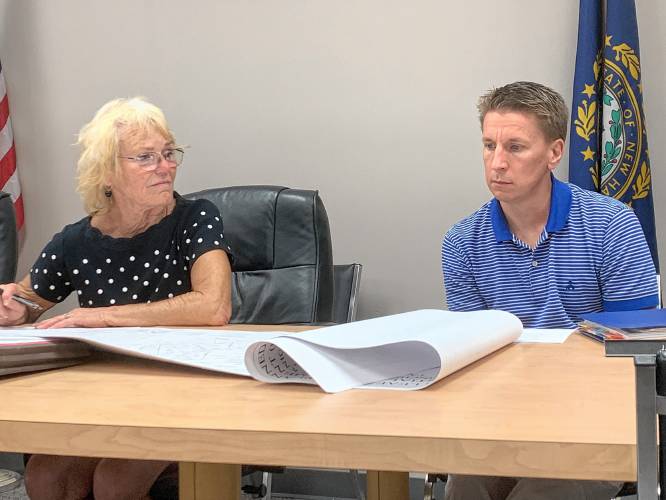 Planning Board Chair Roberta Oeser and Vice Chair Joel Aho review plans for a 14-lot subdivision during a meeting on Tuesday.