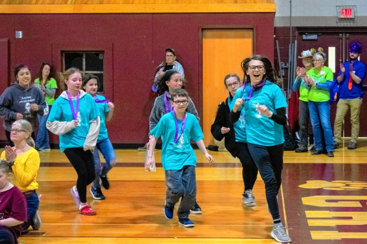 Wearing their winning medals, the Conant Middle High School Destination Imagination team takes a vicory lap during the closing ceremony at the Destination Imagination state affiliate finals on Saturday.