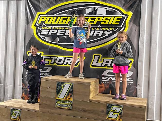Raelin Deschenes on the podium after winning in the Rookie Champ division at Poughkeepsie Speedway.