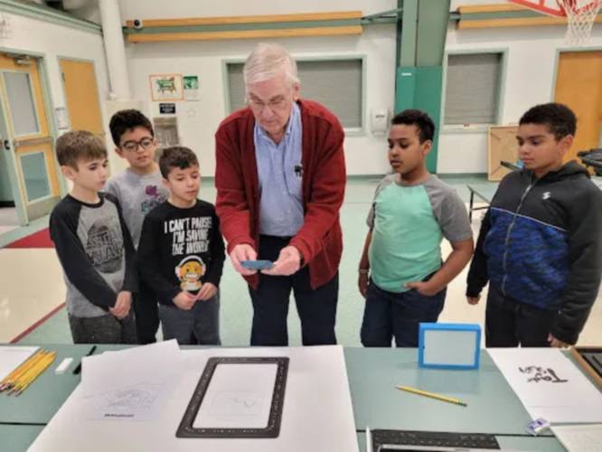 David Dewitt shows fourth-grade students, from left, Nathan Slocomb, Andre Rodriguiz, Carter Morell, Jesse Fornier and Israel Hicks how to use the 3D printer which was coded to print their original drawings.