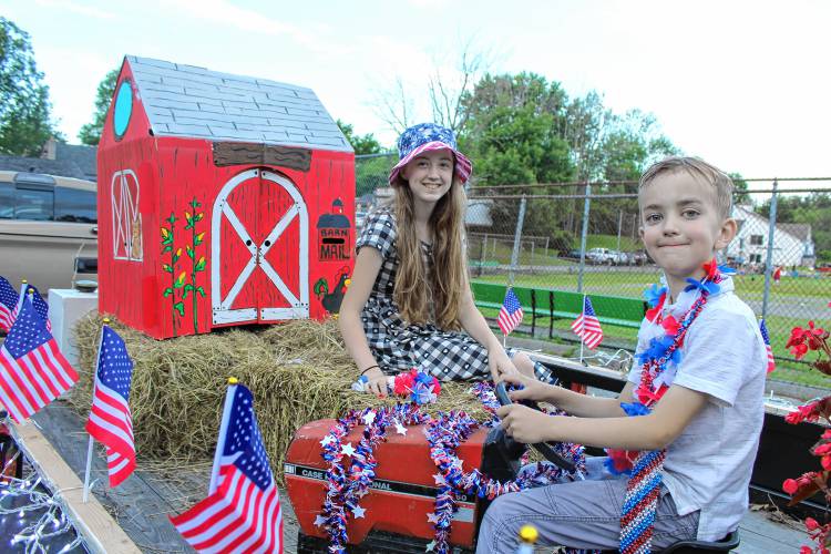 Elisabeth Horsley, 12, and John Horsley, 8, ready their “Country Bumpkin”-themed float, representing their family farm, for the Pots and Pans Parade.